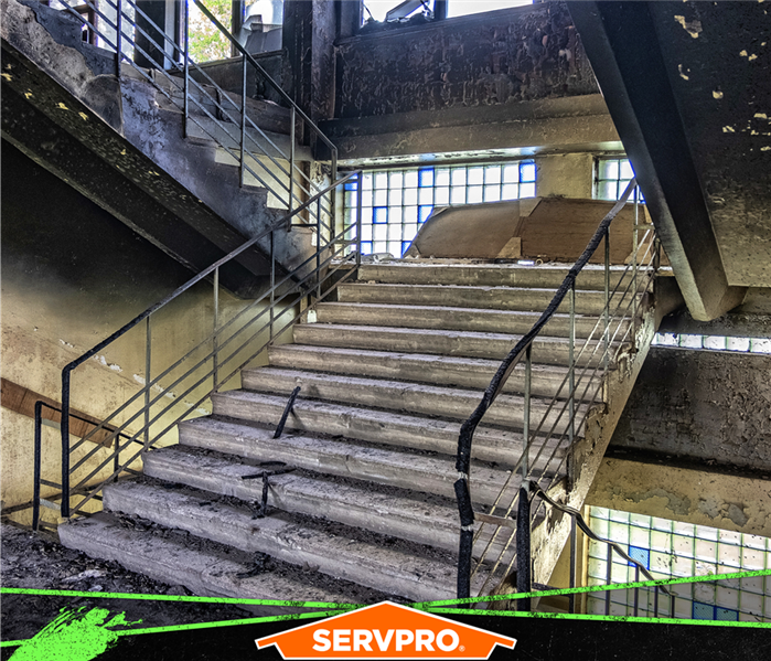 Image of staircase with soot stains on the walls and ceiling from a fire.