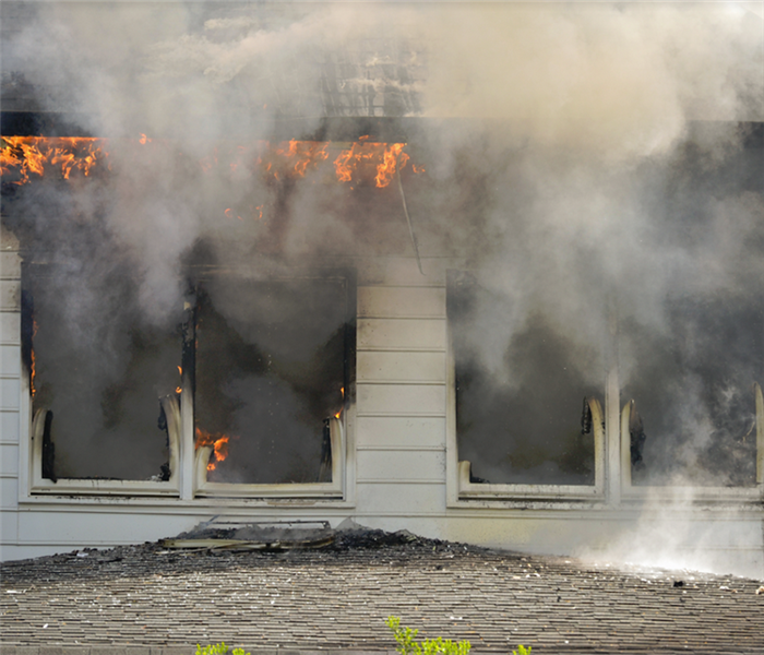 a house on fire with smoke coming out of the windows